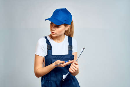 Woman courier in uniform documents service deliveryの写真素材