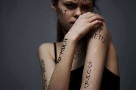 Woman with inscriptions on the body frustration and dissatisfaction emotions lifestyle gray...