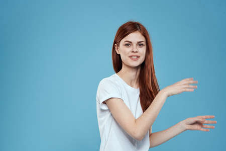 pretty woman white tshirt long hair glamor lifestyle cropped view blue backgroundの写真素材