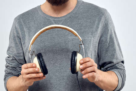 Man holding headphones in the hands of a man lifestyle modern style technology cropped view