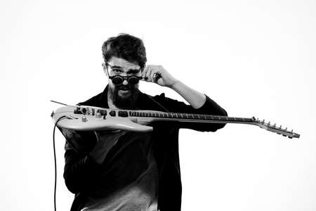 man with guitar in hands musician rock star performance lifestyle light backgroundの写真素材