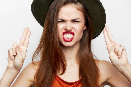 Woman in a green hat Passionate glance gestures with his handsの写真素材