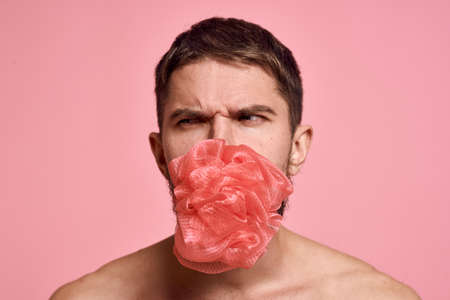 bearded man with bare shoulders with a washcloth clean skin bathroomの写真素材
