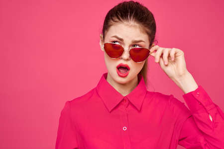 Woman in pink shirt and brown glasses cropped view fashion model emotions gesturing hands portrait