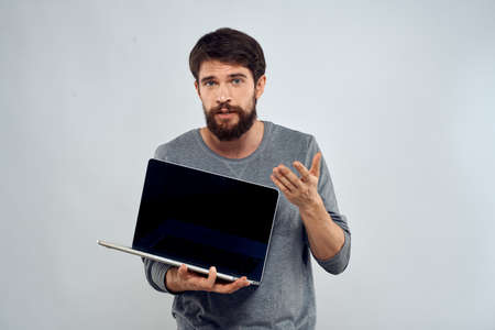 man holding laptop technology internet work communication light backgroundの写真素材