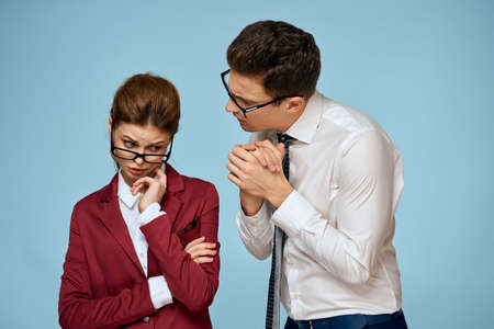 business man and woman office officials communication work colleagues studio blue backgroundの写真素材