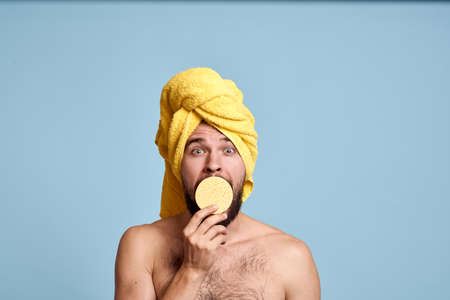 a man with a yellow towel on his head bum bare shoulders clean skin taking a showerの写真素材