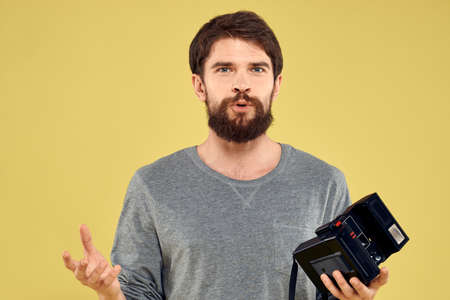 Photo camera in the hands of a man professional equipment hobby Creative approach studio cropped...