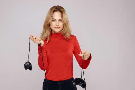Pretty woman with gamepads playing entertainment leisure lifestyle light background