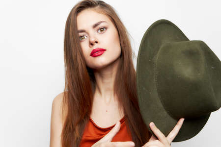 Woman holding hat Long hair smile charm near face red sundressの写真素材