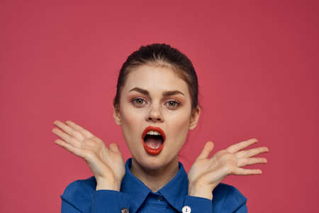Portrait of emotional woman in blue shirt with bright makeup gesturing with hands Copy Space