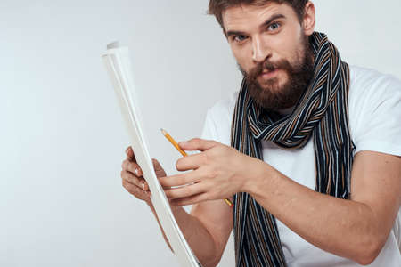 Male artist sitting on chair drawing brush easel hobby Creative light background