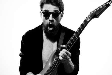 man with guitar in hands musician rock star performance lifestyle light backgroundの写真素材