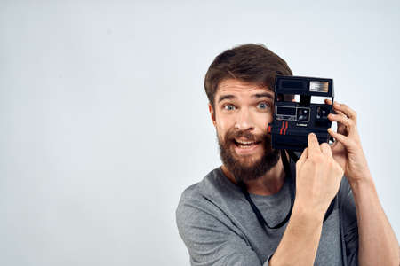 male photographer holding camera professional lens creative studio work light backgroundの写真素材