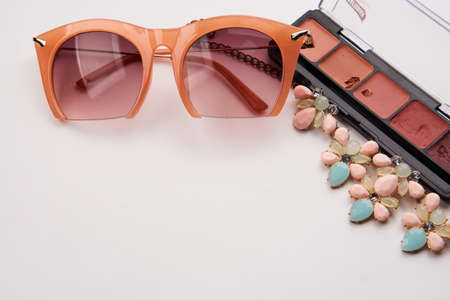 Professional cosmetics makeup brushes light background Copy Space glasses