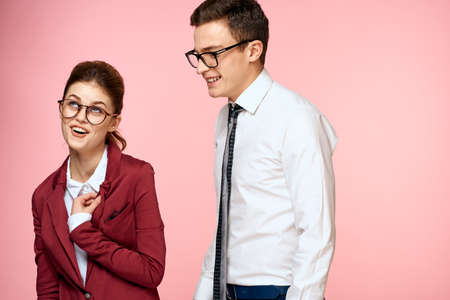 business man and woman office work colleagues team office management studio pink backgroundの写真素材