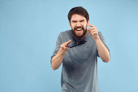 Emotional man with a tablet in the hands of a wireless device internet technology lifestyle blue...