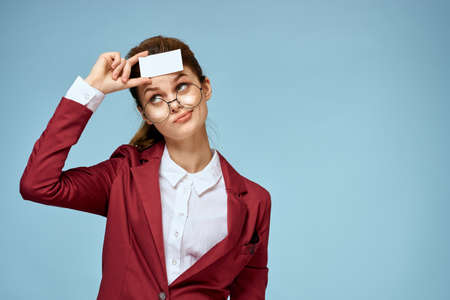 Business woman red jacket business card glasses executive blue background