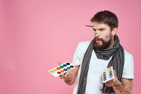 Male artist brush paints art hobby lifestyle pink backgroundの写真素材