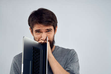 man holding laptop technology internet work communication light background