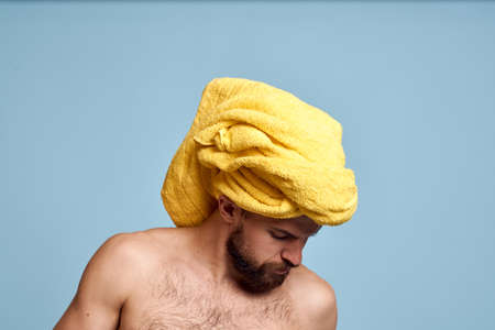 man with bare shoulders yellow towel on his head cotton swabs hygiene care