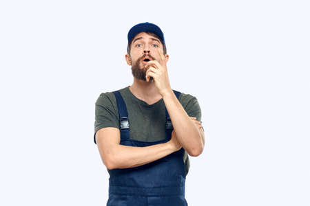 Worker man uniform delivery service emotions studio light backgroundの写真素材