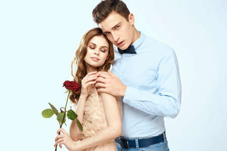 Young couple romance hug relationship dating red rose light studio backgroundの写真素材