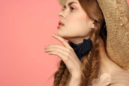 Romantic girl with pigtails and in a straw hat smile romance pink background Copy Space