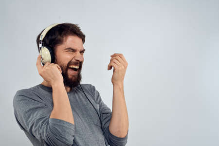 Man in headphones listens to music lifestyle modern style technology light background