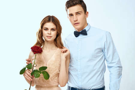 Young couple romance hug relationship dating red rose light studio background