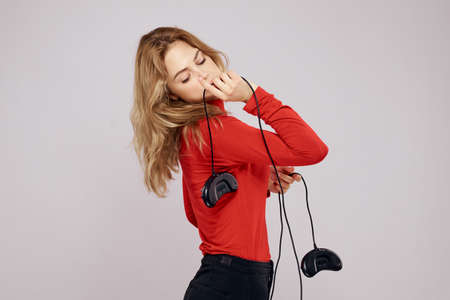 Pretty woman with gamepads playing entertainment leisure lifestyle light background