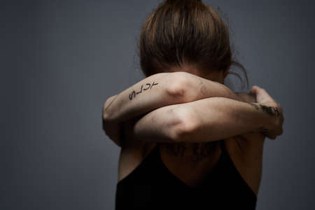 woman with offensive inscriptions on her body touching herself with hands stress frustration hate