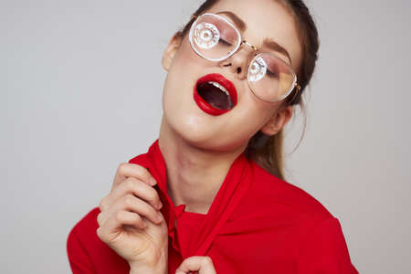 attractive woman with bright makeup and light background gesturing with hands cropped view emotion funの写真素材