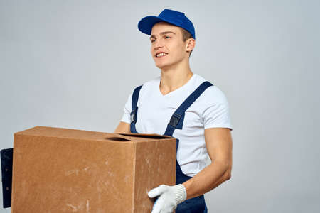Man worker with box in hands delivery loading service packing service