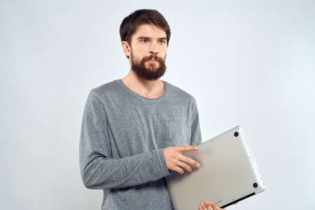 Emotional man holding a laptop success modern style work light background