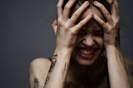 upset woman with offensive writing on her body on gray background touching herself with hands cropped viewの写真素材