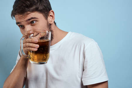 Drunk man beer mug fun white t-shirt lifestyle blue backgroundの写真素材