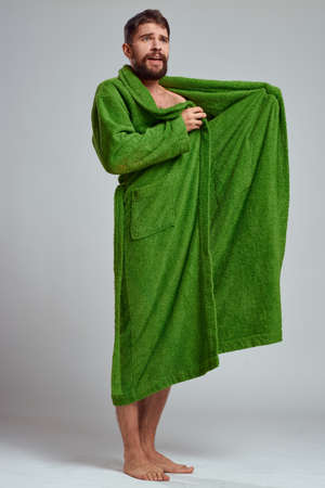 emotional man in a green robe on a light background in full growth fun emotions modelの写真素材