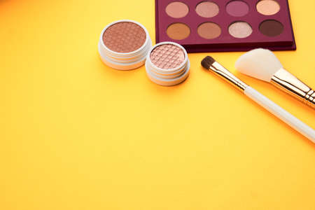 Eyeshadow eye makeup brush on yellow background top view Copy Spaceの写真素材