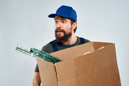 Male worker loading delivery boxes in hands packing lifestyleの写真素材