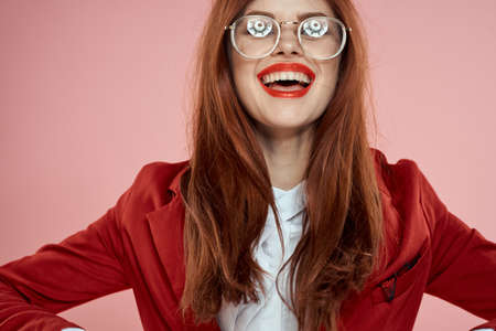Elegant woman wearing glasses red lips jacket long hair pink