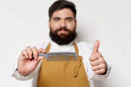 Male hairdresser combing positive hand gesture barbershopの写真素材