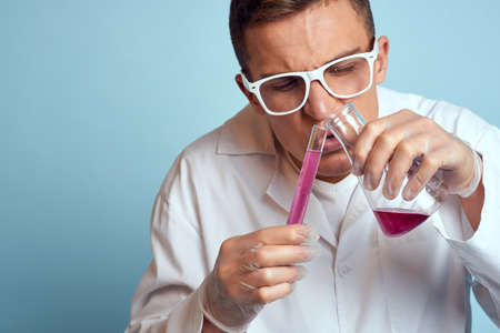 man holding flasks colorful liquid chemical laboratory model wearing glasses