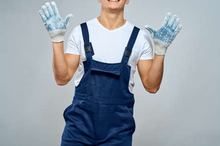 Man worker in forklift uniform delivery service light backgroundの写真素材