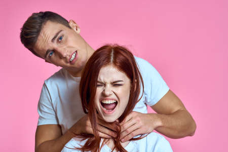 Family violence woman and man pink background emotions modelの写真素材