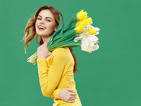 Woman with a bouquet of tulips gift joy holiday funの写真素材