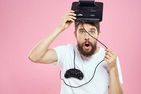 Man with prefix in hand joystick games lifestyle fun pink background white t-shirt
