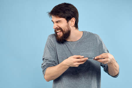 Man with tablet in hands technology lifestyle wireless device blue backgroundの写真素材