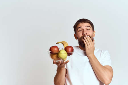 man with fresh fruit in a glass cup gesturing with hands vitamins health energy model bushy beard mustacheの写真素材
