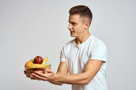 Man with fresh fruit in a cup health lifestyle healthy nutrition vitaminsの写真素材